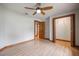 Bedroom featuring a ceiling fan, wood floors, and closet at 929 Hammock Shade Dr, Lakeland, FL 33809