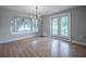 Dining area featuring a modern light fixture, bay window and back door at 929 Hammock Shade Dr, Lakeland, FL 33809