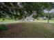 Charming home exterior with a well-manicured lawn, and a picturesque white picket fence, exuding curb appeal at 929 Hammock Shade Dr, Lakeland, FL 33809