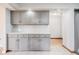 The kitchen has sleek grey cabinets and modern fixtures, flowing into an open area at 929 Hammock Shade Dr, Lakeland, FL 33809