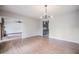Spacious living room features an open layout with hardwood flooring and a modern chandelier at 929 Hammock Shade Dr, Lakeland, FL 33809