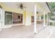 Covered patio with ceiling fans, columns, and view to backyard at 929 Hammock Shade Dr, Lakeland, FL 33809
