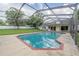 A lovely backyard pool features a pool cleaner, screen enclosure, brick trim, and nice backyard at 929 Hammock Shade Dr, Lakeland, FL 33809
