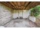 View of the concrete floor of under deck, with white brick columns and a wooden ceiling at 929 Hammock Shade Dr, Lakeland, FL 33809