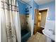 Cozy bathroom featuring a shower-tub combo with designer fixtures and a vintage-style sink at 938 E Lowell St, Lakeland, FL 33805