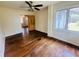 Inviting bedroom featuring hardwood floors and a ceiling fan, creating a comfortable retreat at 938 E Lowell St, Lakeland, FL 33805