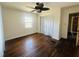 Bright bedroom with hardwood floors and ceiling fan, offering a peaceful and inviting space at 938 E Lowell St, Lakeland, FL 33805