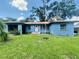 Charming single-story home featuring a metal roof and an expansive well-manicured front yard at 938 E Lowell St, Lakeland, FL 33805