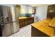 Well-equipped kitchen featuring butcher block countertops, stainless steel appliances, and tiled flooring at 938 E Lowell St, Lakeland, FL 33805