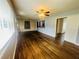 Bright living room showcasing gleaming hardwood floors, ceiling fan, and windows with custom blinds at 938 E Lowell St, Lakeland, FL 33805