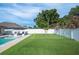 Lush backyard showcasing a pool, putting green, and outdoor seating under the sun at 967 Hunters Meadow Ln, Lakeland, FL 33809