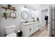 Bright bathroom with double sink vanity, granite countertop, and modern fixtures at 967 Hunters Meadow Ln, Lakeland, FL 33809