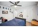 Well-lit bedroom featuring modern ceiling fan, sporty decor, and wood-look flooring at 967 Hunters Meadow Ln, Lakeland, FL 33809