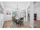 Elegant dining area with modern chandelier, wood floors, and ample natural light at 967 Hunters Meadow Ln, Lakeland, FL 33809