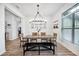 Spacious dining area featuring wood floors, modern lighting, and a large window for natural light at 967 Hunters Meadow Ln, Lakeland, FL 33809