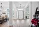 Bright entryway with wood flooring, a modern light fixture, and views into the living spaces at 967 Hunters Meadow Ln, Lakeland, FL 33809