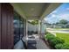 Cozy front porch with seating, showcasing the landscaped yard and neighborhood view at 967 Hunters Meadow Ln, Lakeland, FL 33809