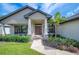 Charming front entrance with well-maintained landscaping, stone accents, and a covered porch at 967 Hunters Meadow Ln, Lakeland, FL 33809