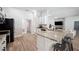 Modern kitchen with granite countertops, white cabinets, and eat-in bar seating at 967 Hunters Meadow Ln, Lakeland, FL 33809