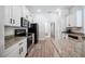 Well-lit kitchen with white cabinets, granite countertops, and stainless steel appliances at 967 Hunters Meadow Ln, Lakeland, FL 33809