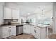 Bright kitchen features white cabinets, stainless steel appliances, and granite countertops overlooking breakfast nook at 967 Hunters Meadow Ln, Lakeland, FL 33809
