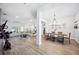 Open-concept living and dining area with wood floors and modern chandelier at 967 Hunters Meadow Ln, Lakeland, FL 33809