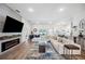 Bright, open living room with fireplace, large sectional sofa, and view of kitchen at 967 Hunters Meadow Ln, Lakeland, FL 33809