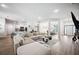 Open-concept living room with modern furnishings, neutral colors and wood-style flooring at 967 Hunters Meadow Ln, Lakeland, FL 33809
