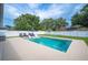 Relaxing backyard with private pool, lounge chairs, and meticulously manicured landscaping at 967 Hunters Meadow Ln, Lakeland, FL 33809