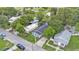 An aerial view shows the house, surrounding neighborhood and green trees at 980 S Mill Ave, Bartow, FL 33830