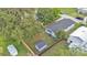 An aerial view of the house with a fenced in yard and storage building at 980 S Mill Ave, Bartow, FL 33830