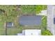 Aerial view of the house shows a gray roof, green trees and nice backyard at 980 S Mill Ave, Bartow, FL 33830