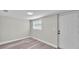 Finished basement featuring wood-look floors, a window, and a door at 980 S Mill Ave, Bartow, FL 33830
