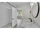 Bathroom featuring a new shower, subway tile, decorative mirror, and modern vanity at 980 S Mill Ave, Bartow, FL 33830