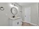 Updated bathroom with modern vanity, decorative mirror, and contemporary fixtures at 980 S Mill Ave, Bartow, FL 33830