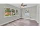Bedroom featuring wood-look floors, ceiling fan and backyard views at 980 S Mill Ave, Bartow, FL 33830