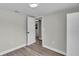 Bedroom featuring wood-look floors, leading to closet space and bathroom space at 980 S Mill Ave, Bartow, FL 33830