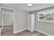 Simple bedroom featuring wood-look floors, a window, and a large closet at 980 S Mill Ave, Bartow, FL 33830