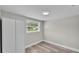 Simple bedroom featuring wood-look floors, a window, and a large closet at 980 S Mill Ave, Bartow, FL 33830
