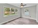 Bedroom with wood-look floors, ceiling fan and backyard views at 980 S Mill Ave, Bartow, FL 33830