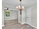 Open dining room with modern chandelier, seamless flow, and sleek, contemporary design at 980 S Mill Ave, Bartow, FL 33830