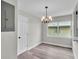Dining area with stylish light fixture and natural light, enhanced by sleek, modern flooring at 980 S Mill Ave, Bartow, FL 33830
