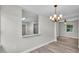 Bright dining room with new light fixture and pass-through to kitchen, showcasing modern design at 980 S Mill Ave, Bartow, FL 33830