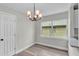 Dining area with elegant lighting fixture, natural light, and sleek, modern flooring at 980 S Mill Ave, Bartow, FL 33830