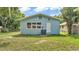 The home's exterior shows the back yard, side door, and air conditioning unit at 980 S Mill Ave, Bartow, FL 33830
