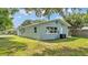 The home's exterior shows the back yard, side door, and yard at 980 S Mill Ave, Bartow, FL 33830
