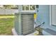 Exterior AC unit of the home is shown on a concrete slab with grass around it at 980 S Mill Ave, Bartow, FL 33830