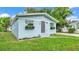 Charming blue home with a well-manicured lawn and flower boxes under the windows at 980 S Mill Ave, Bartow, FL 33830