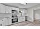 Modern kitchen with white cabinets, stainless steel appliances, and light gray countertops at 980 S Mill Ave, Bartow, FL 33830