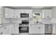 Updated kitchen featuring white cabinetry, stainless steel appliances, and a subway tile backsplash at 980 S Mill Ave, Bartow, FL 33830
